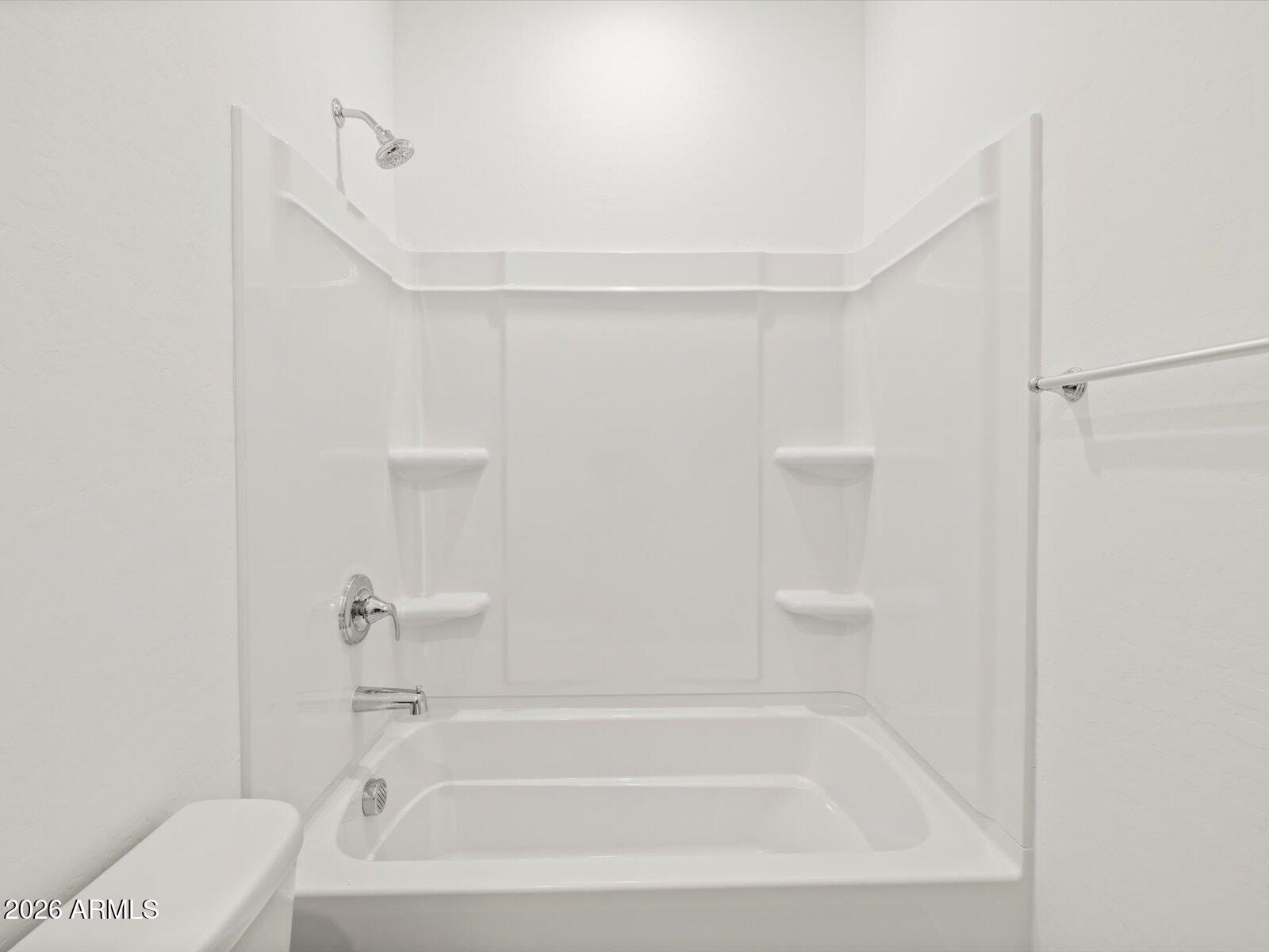 8936 South 244th Lane Buckeye, AZ 85326 - Photo 7 of 45 a bathroom with a bathtub and a shower