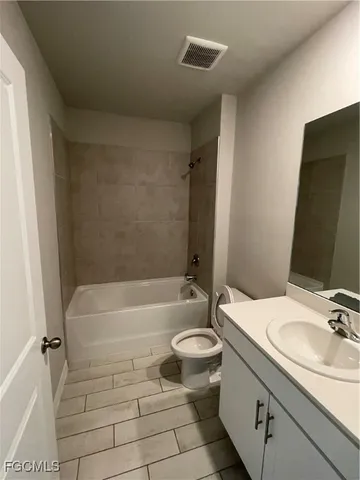 a bathroom with a sink a toilet and bathtub