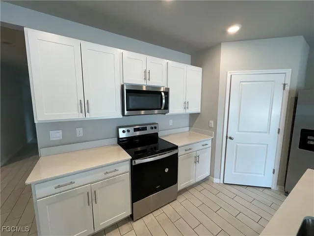 a kitchen with a sink a stove and refrigerator