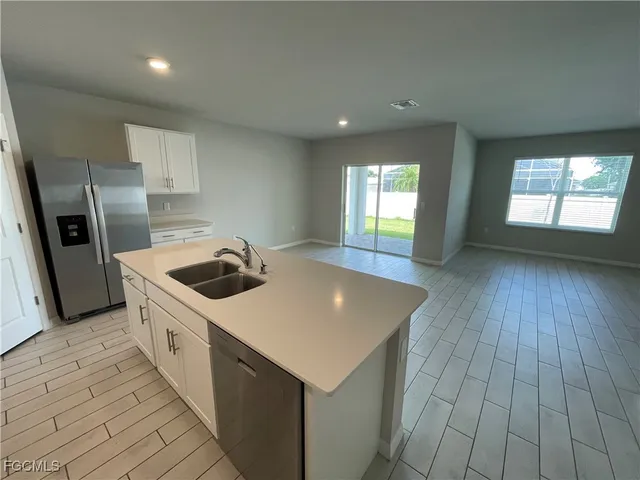 a kitchen that has a sink and a stove top oven