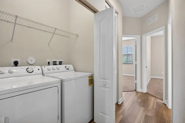 a view of storage and utility room with washer and dryer