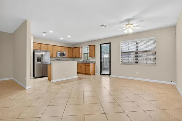 a view of a kitchen with furniture and wooden floor