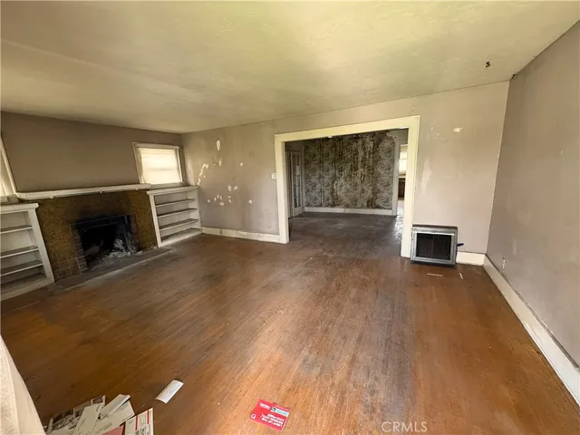 wooden floor in an empty room with a fireplace