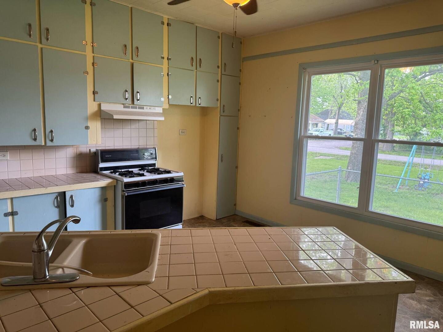604 South 23rd Street Herrin, IL 62948 - Photo 9 of 14 a kitchen with stainless steel appliances kitchen island granite countertop a refrigerator and a stove top oven