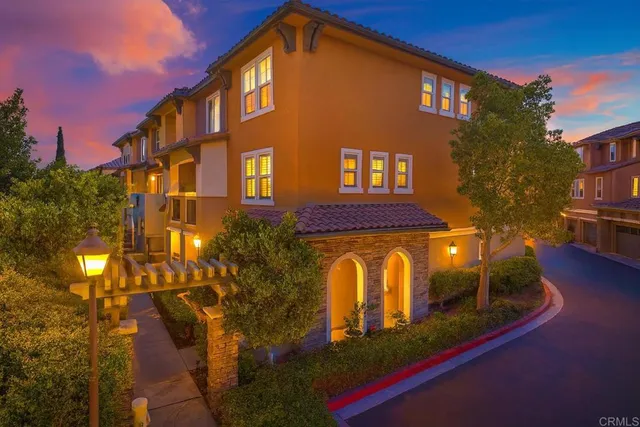 a yellow building with trees in front of it