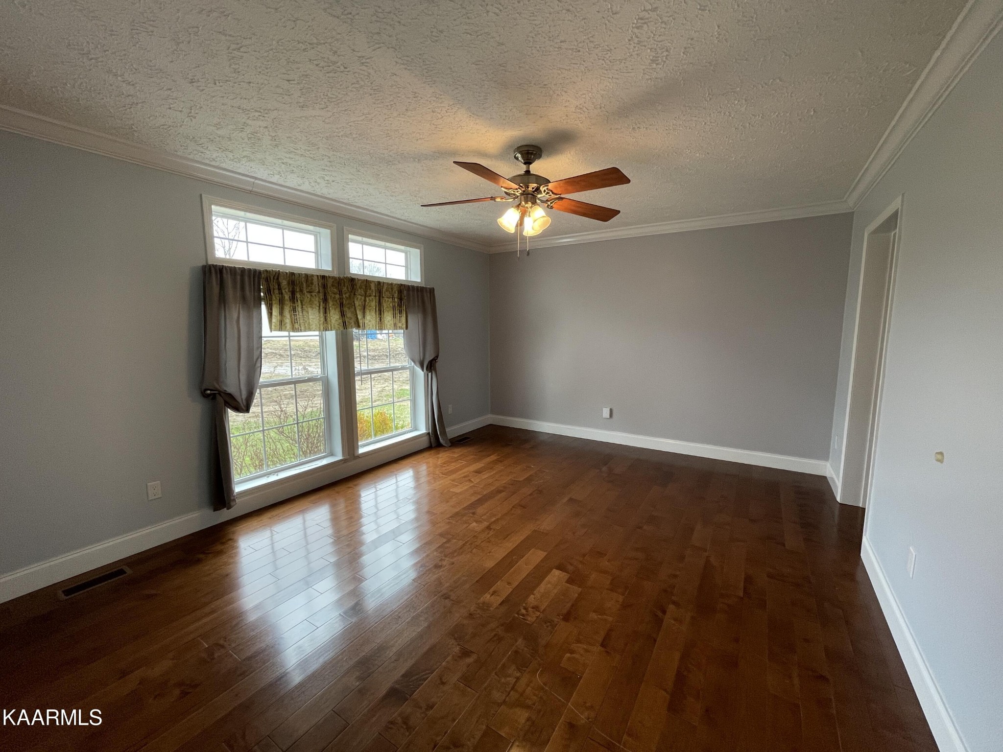 114 George Young Road Jamestown, TN 38556 - Photo 16 of 25 an empty room with wooden floor and windows