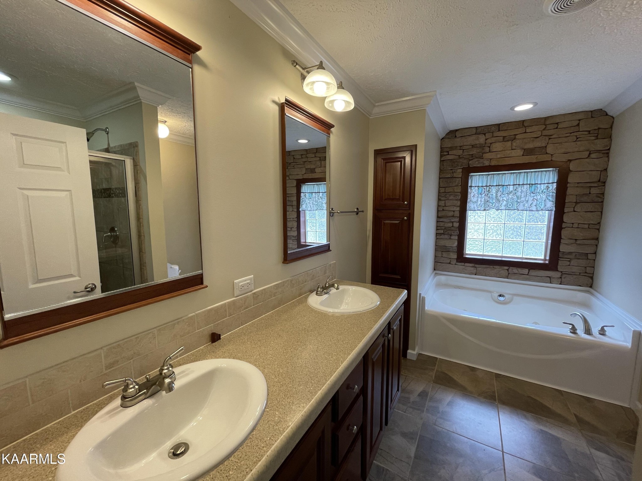 114 George Young Road Jamestown, TN 38556 - Photo 18 of 25 a bathroom with a sink double vanity granite tub shower and a mirror