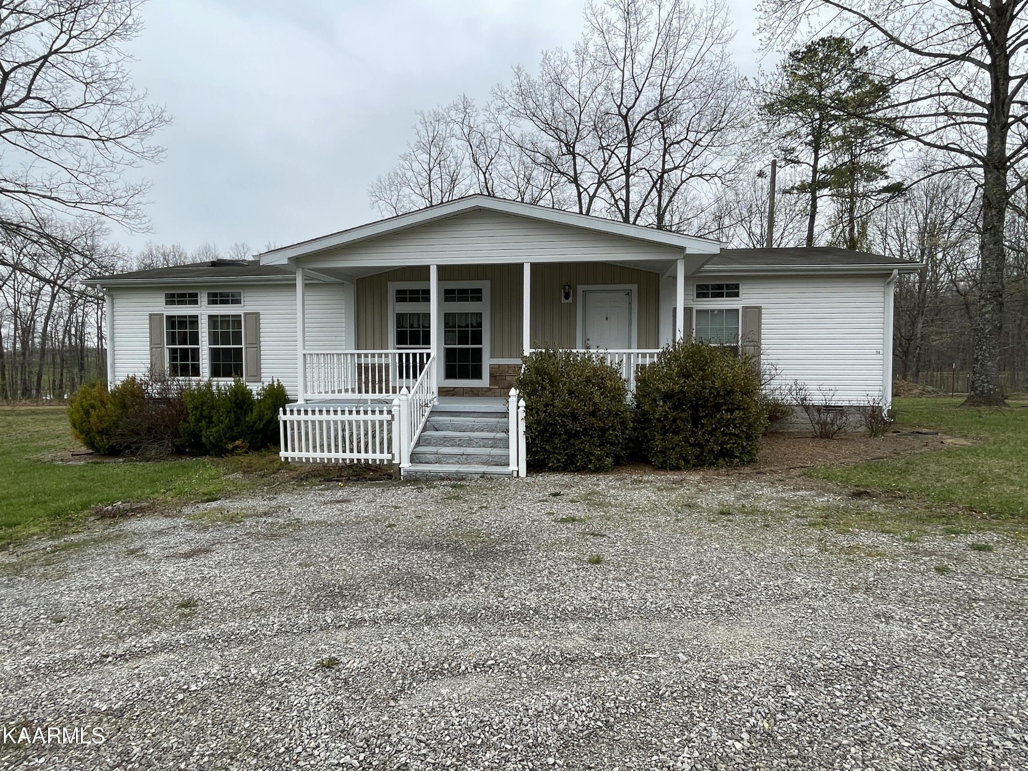 114 George Young Road Jamestown, TN 38556 - Photo 3 of 25 a front view of a house with garden