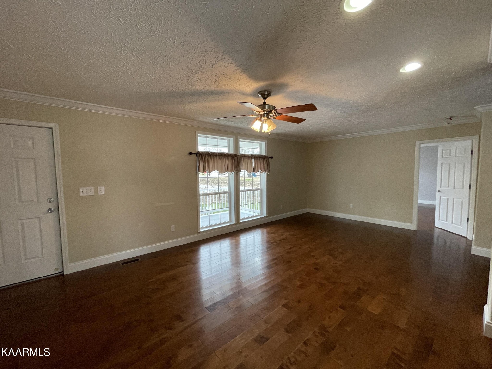 114 George Young Road Jamestown, TN 38556 - Photo 6 of 25 an empty room with wooden floor and windows