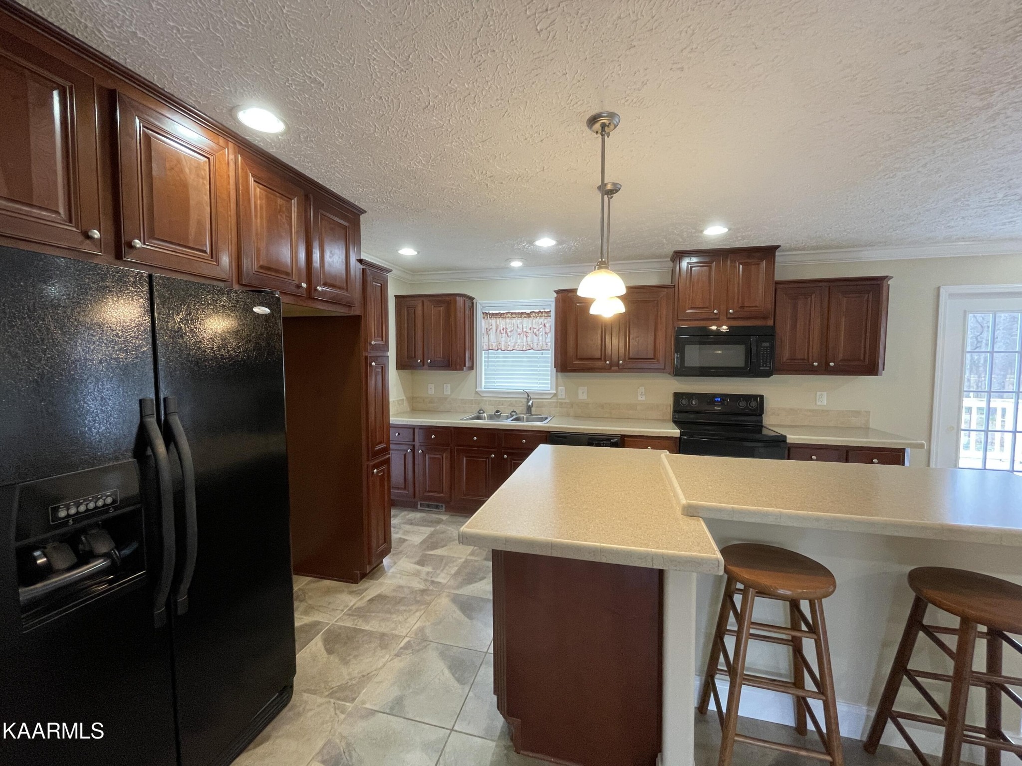 114 George Young Road Jamestown, TN 38556 - Photo 7 of 25 a kitchen with kitchen island a appliances dining table and chairs
