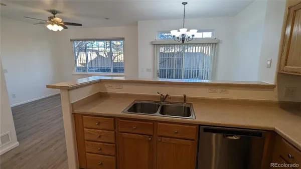 a kitchen with a sink and chandelier