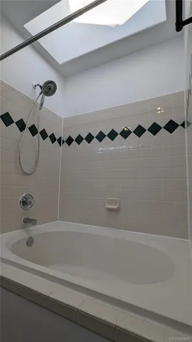 a bathroom with a bathtub and shower