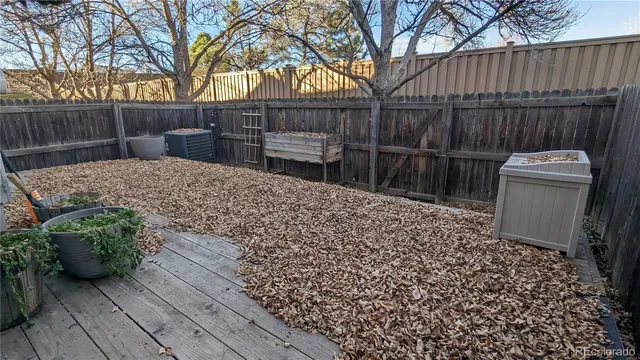 a view of a backyard with wooden fence