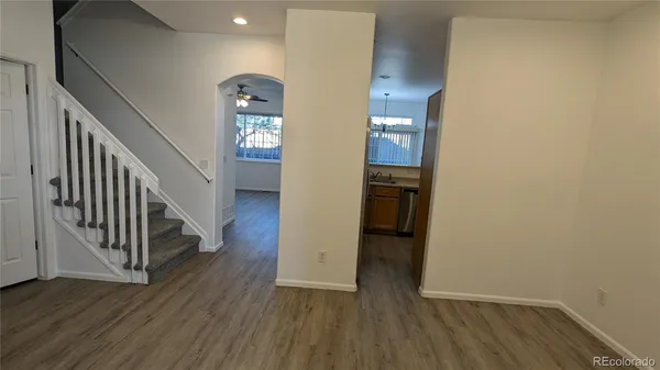 a view of a hallway with wooden floor and entryway