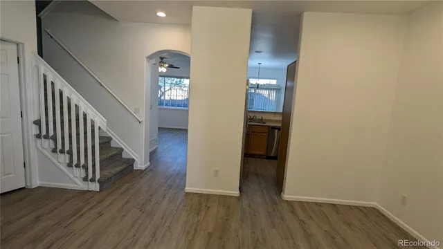 a view of a hallway with wooden floor and entryway