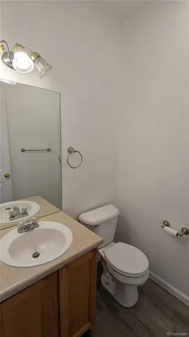a bathroom with a sink a toilet and mirror