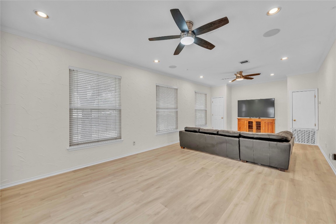 11713 Rydalwater Lane Austin, TX 78754 - Photo 11 of 29 an empty room with a kitchen and windows