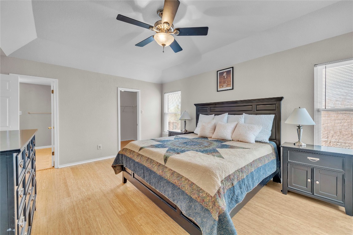 11713 Rydalwater Lane Austin, TX 78754 - Photo 14 of 29 a bedroom with a bed and a chandelier