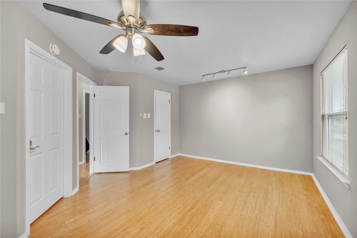 11713 Rydalwater Lane Austin, TX 78754 - Photo 19 of 29 an empty room with windows and fan