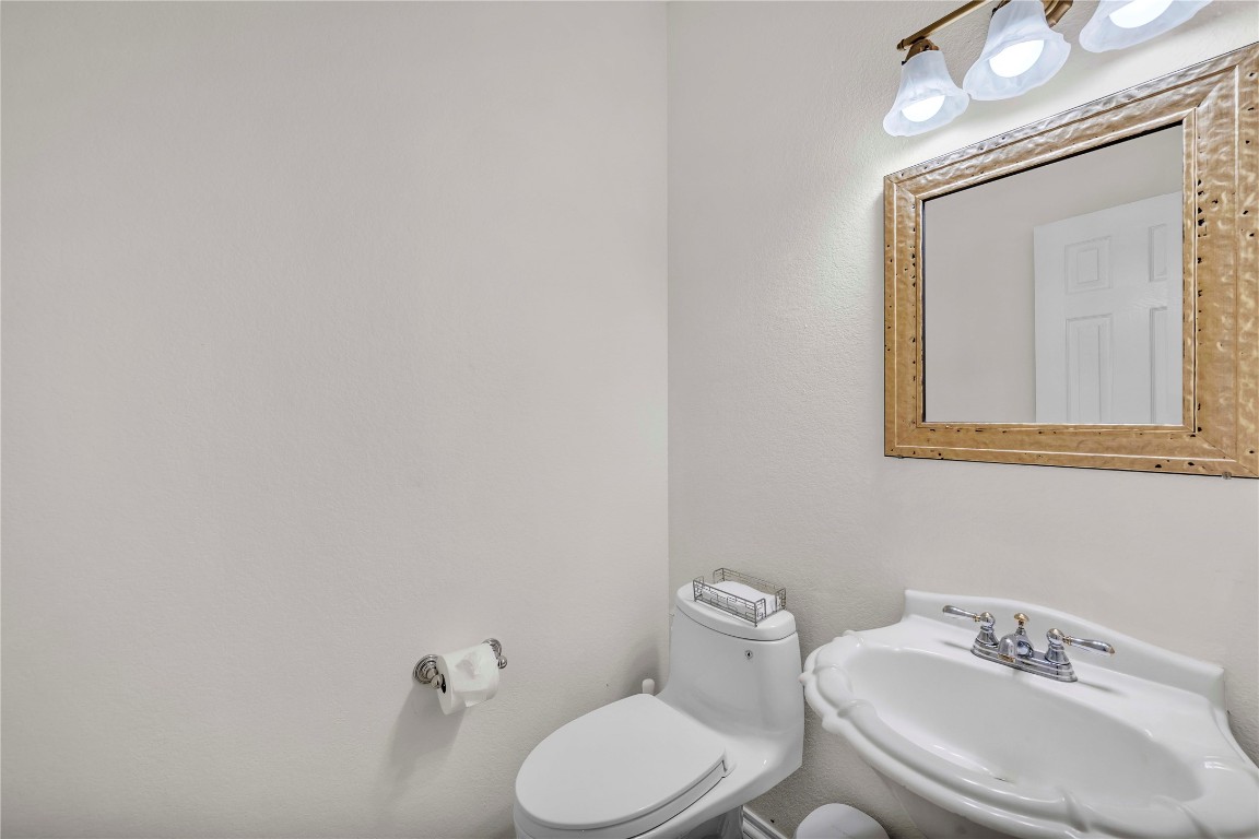 11713 Rydalwater Lane Austin, TX 78754 - Photo 24 of 29 a white toilet sitting next to a bathroom sink