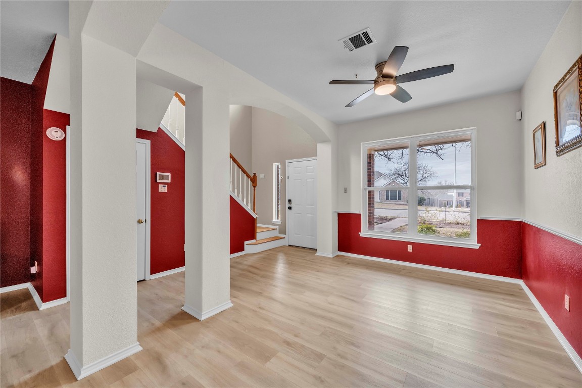 11713 Rydalwater Lane Austin, TX 78754 - Photo 5 of 29 a view of an empty room with window and wooden floor