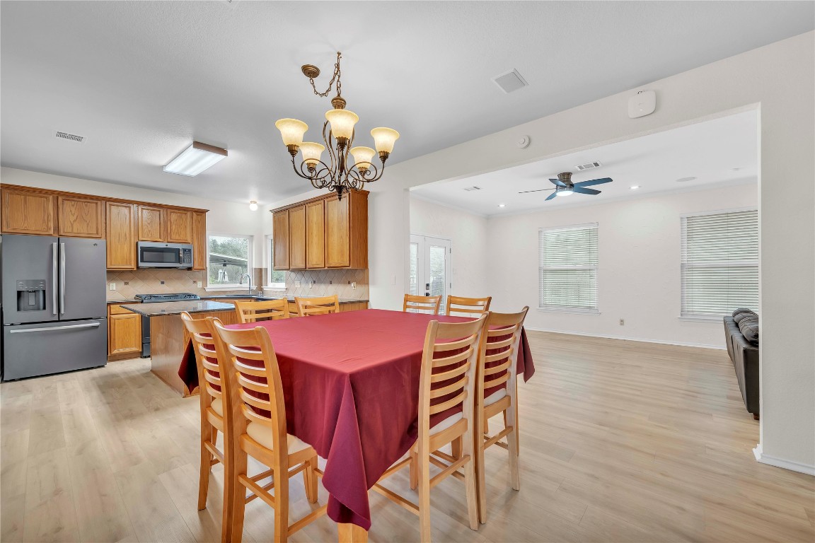 11713 Rydalwater Lane Austin, TX 78754 - Photo 8 of 29 a view of a dining room with furniture and wooden floor