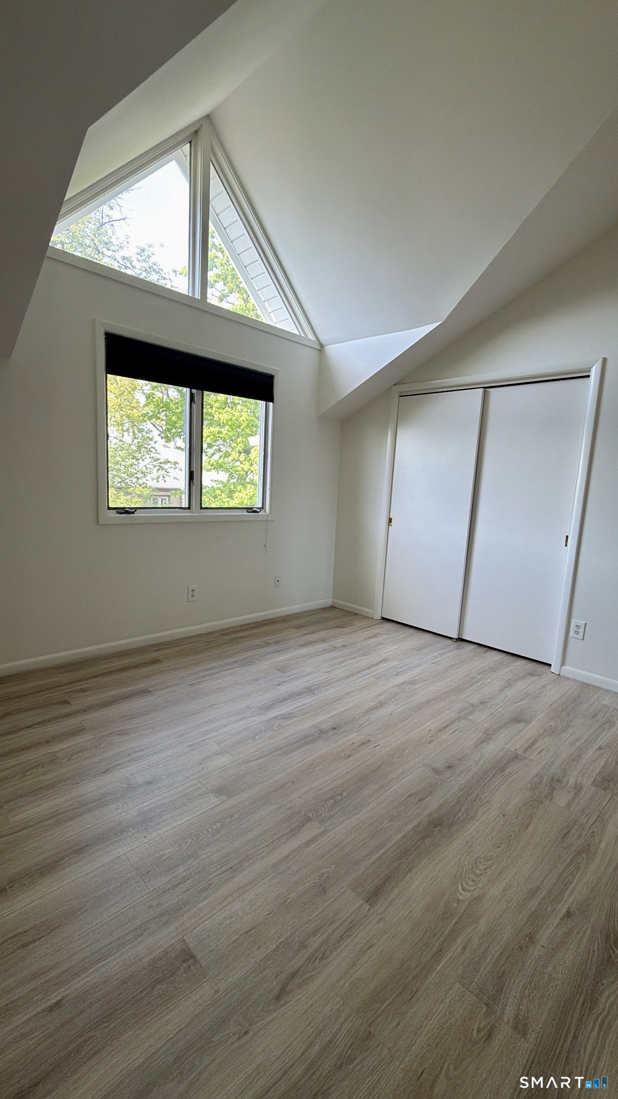 25 Cottage Street, Unit 202 Norwalk, CT 06855 - Photo 15 of 24 an empty room with wooden floor windows and brick walls