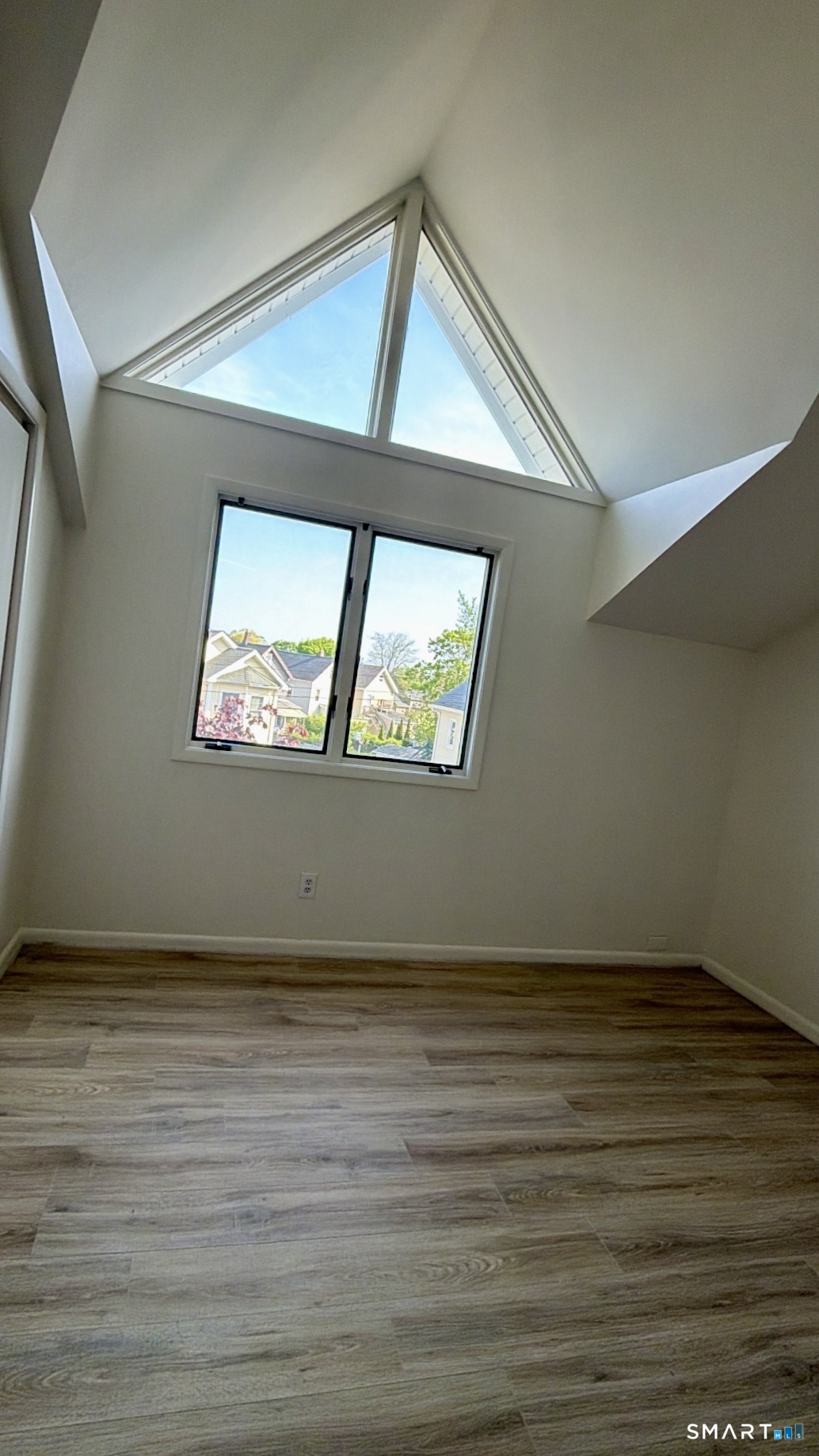 25 Cottage Street, Unit 202 Norwalk, CT 06855 - Photo 17 of 24 a view of an empty room with wooden floor and a window