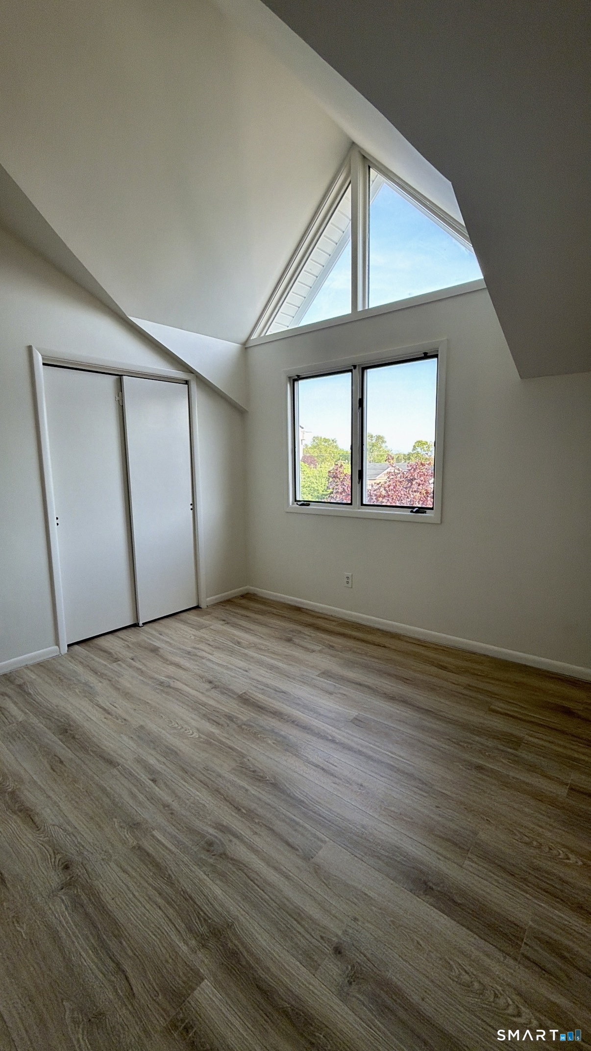 25 Cottage Street, Unit 202 Norwalk, CT 06855 - Photo 18 of 24 an empty room with wooden floor and windows