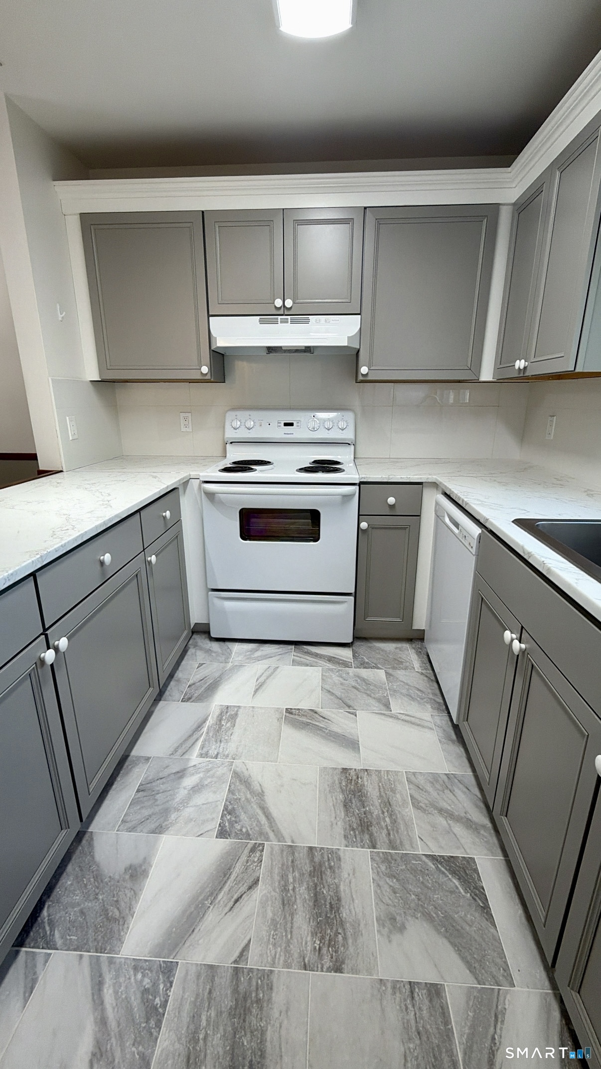25 Cottage Street, Unit 202 Norwalk, CT 06855 - Photo 2 of 24 a kitchen with white cabinets and white appliances