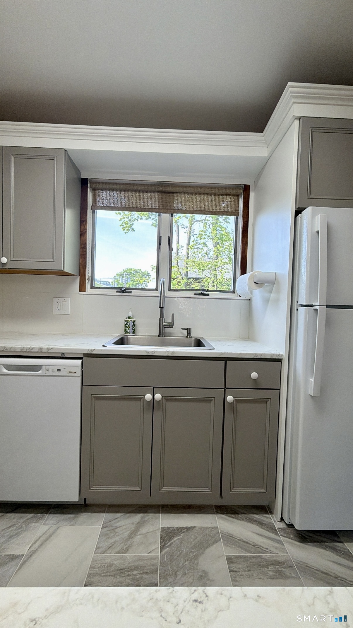 25 Cottage Street, Unit 202 Norwalk, CT 06855 - Photo 3 of 24 a kitchen with a refrigerator sink and cabinets
