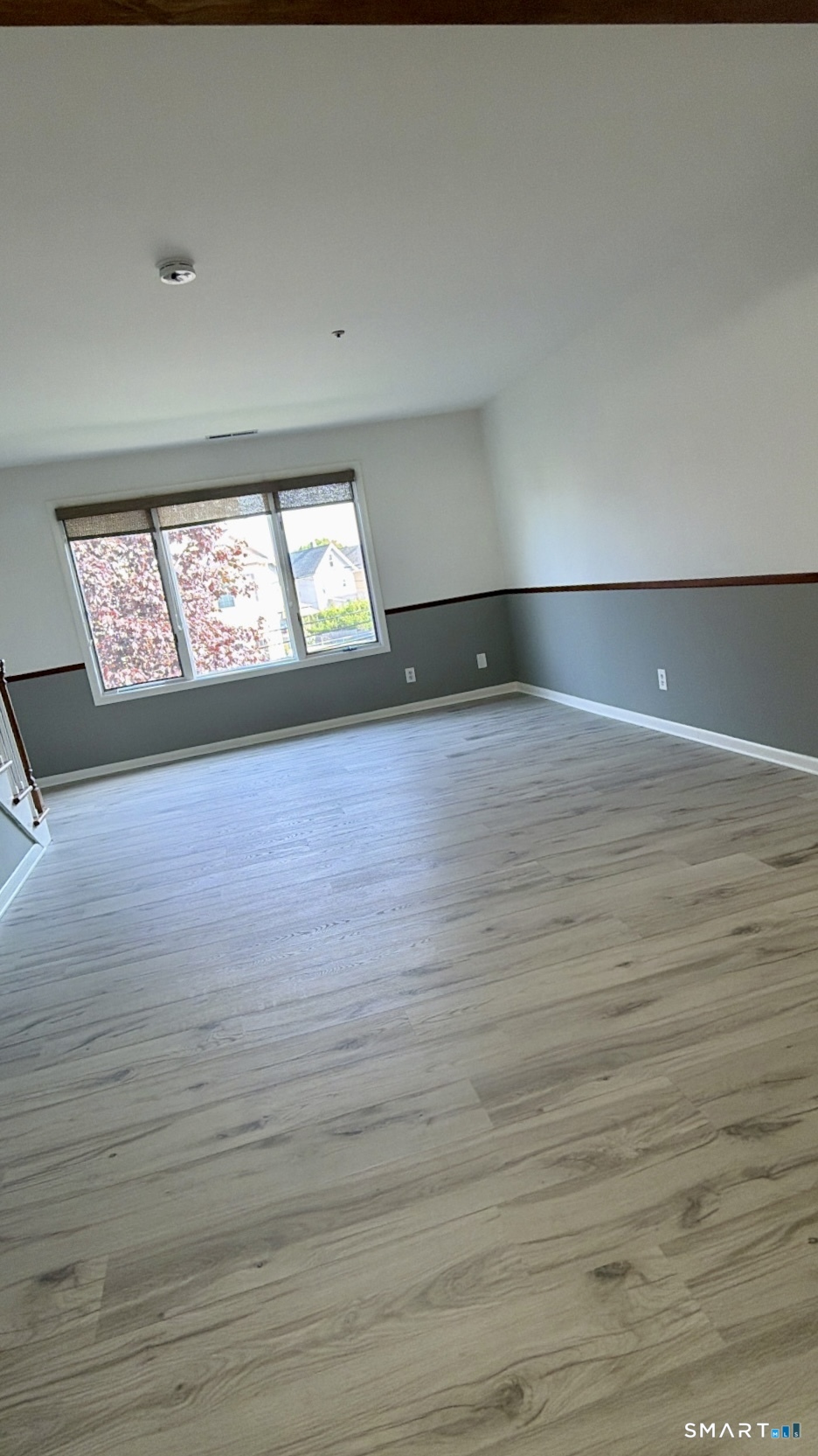 25 Cottage Street, Unit 202 Norwalk, CT 06855 - Photo 8 of 24 an empty room with wooden floor and windows