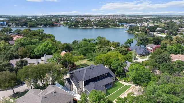 an aerial view of a house with outdoor space and lake view
