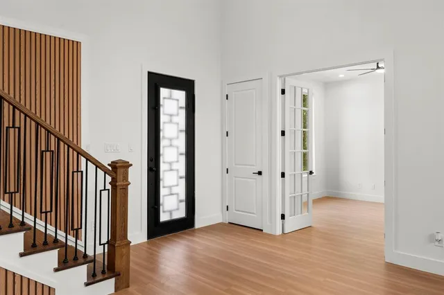 a view of a hallway with wooden floor and entryway