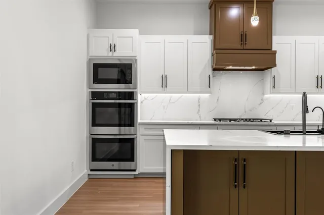 a kitchen with granite countertop a stove and a microwave