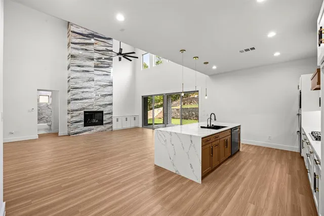 a kitchen with a stove and a wooden floor