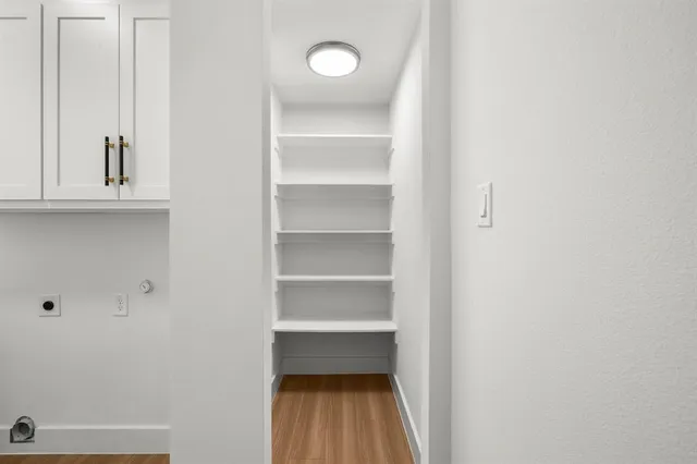 a view of walk in closet with empty racks