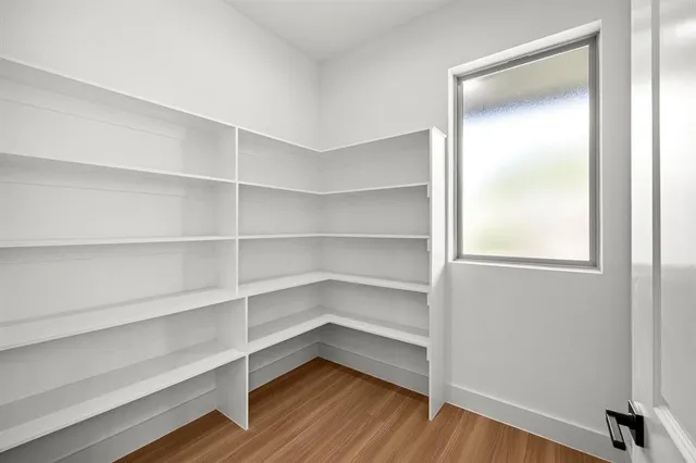 a view of walk in closet with empty racks