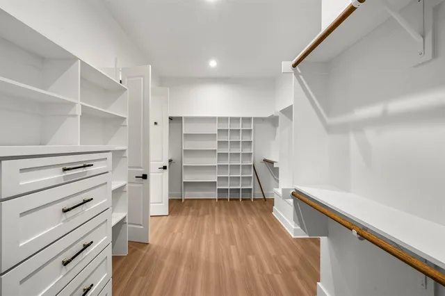 a view of walk in closet with empty racks