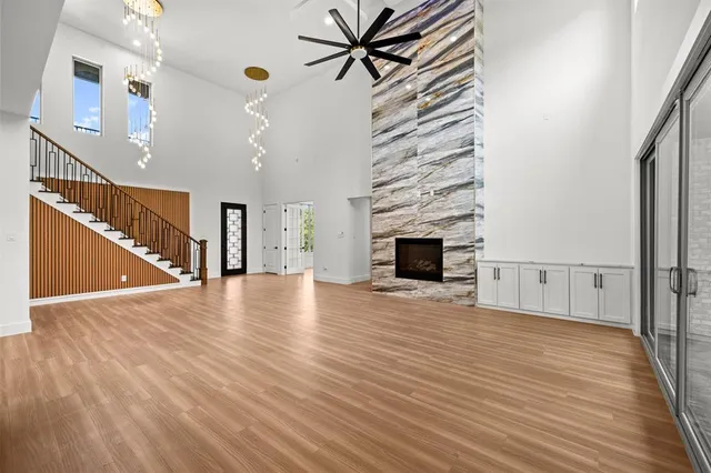 a view of a livingroom with wooden floor and a ceiling fan