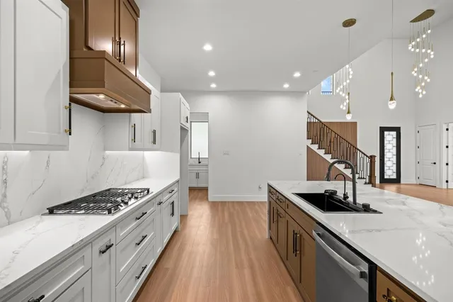 a kitchen with stainless steel appliances granite countertop a sink stove and refrigerator