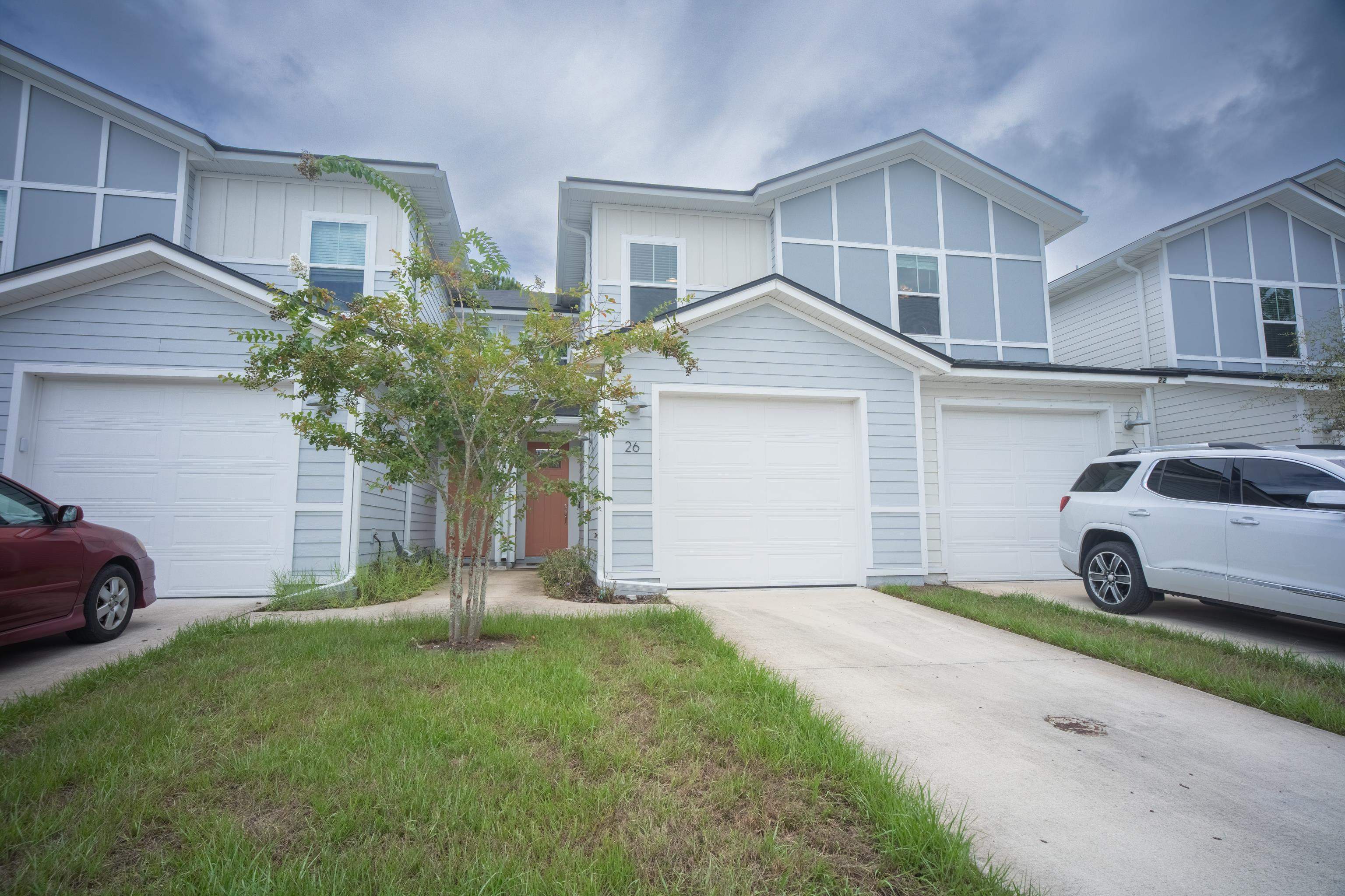 a front view of a house with a yard and garage