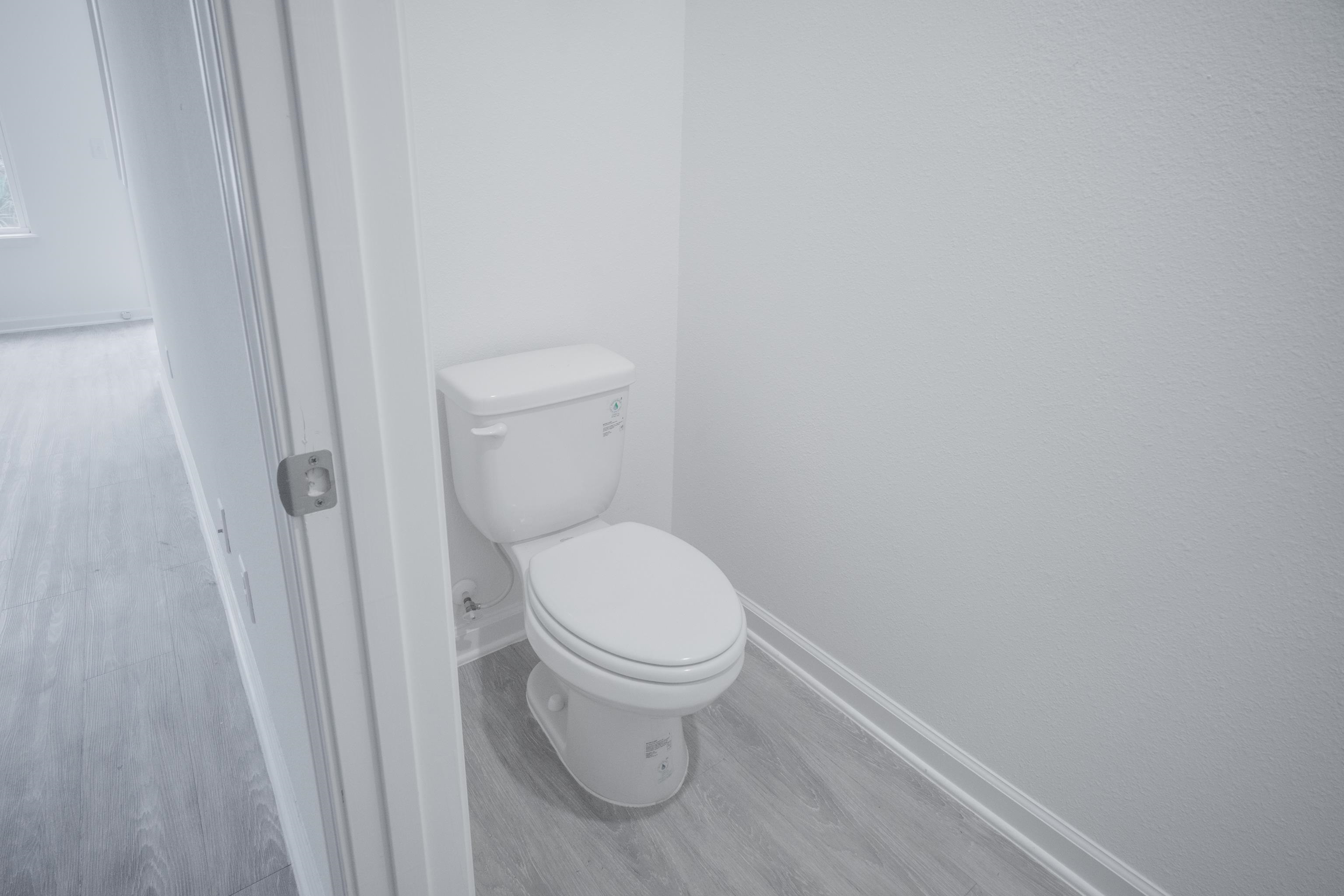 26 Ridge Lake Road St. Augustine, FL 32086 - Photo 18 of 27 a white toilet sitting next to a shower