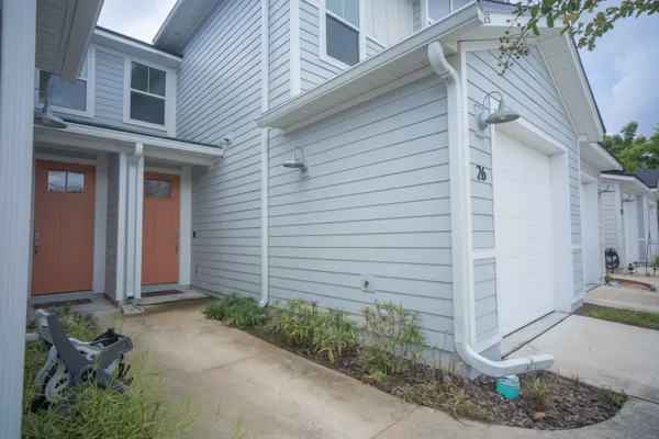 a front view of a house with a garden