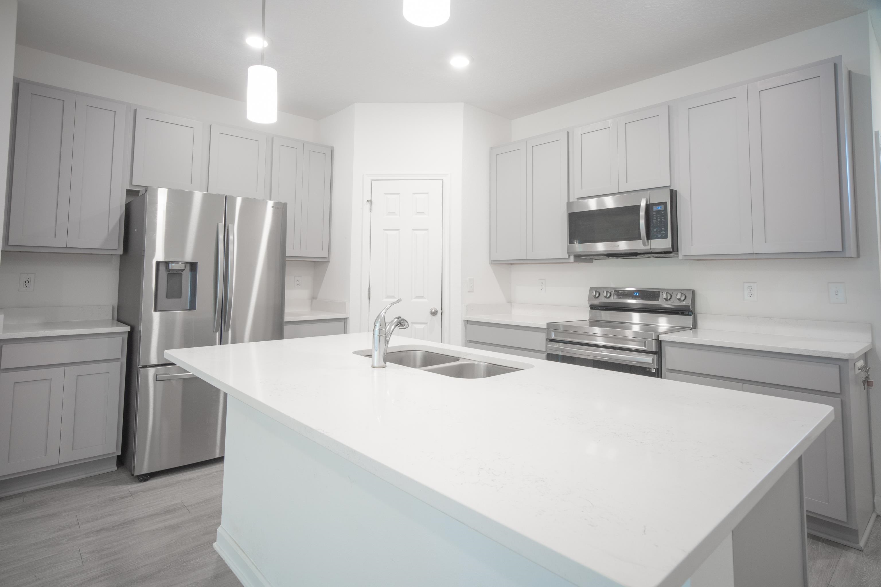 26 Ridge Lake Road St. Augustine, FL 32086 - Photo 3 of 27 a kitchen with stainless steel appliances a microwave sink and refrigerator