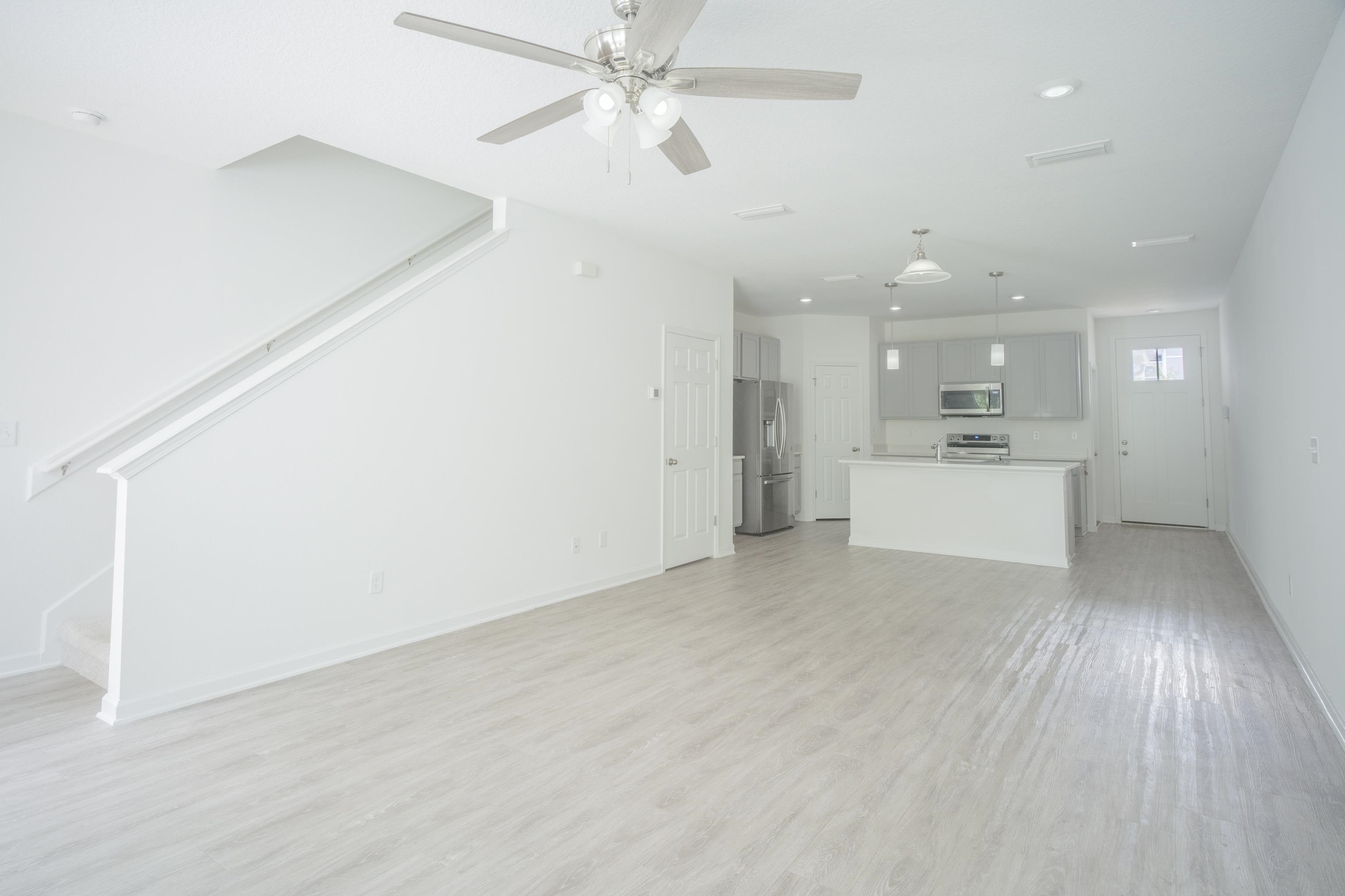 26 Ridge Lake Road St. Augustine, FL 32086 - Photo 5 of 27 wooden floor in an empty room with a kitchen