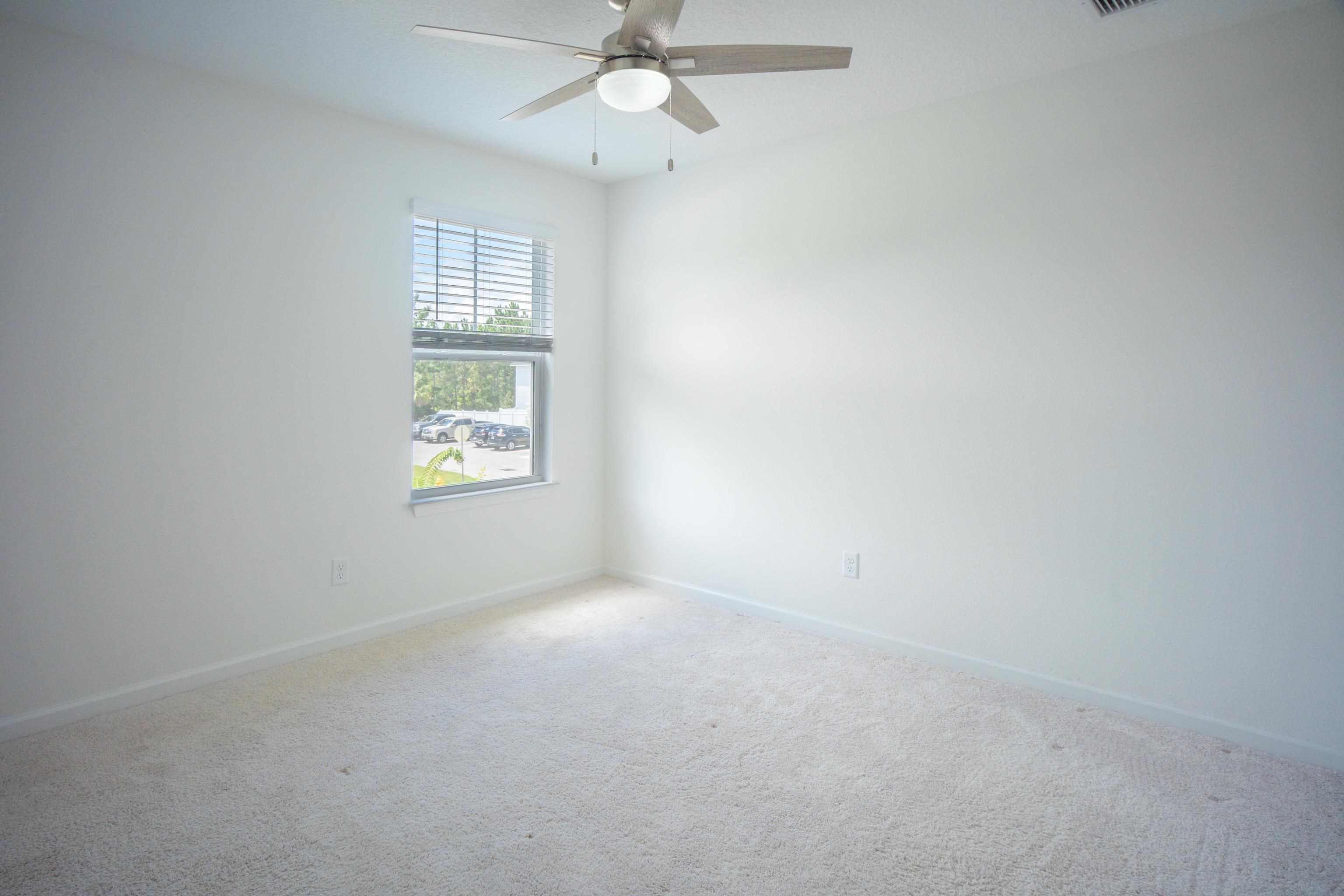 26 Ridge Lake Road St. Augustine, FL 32086 - Photo 8 of 27 an empty room with windows and fan