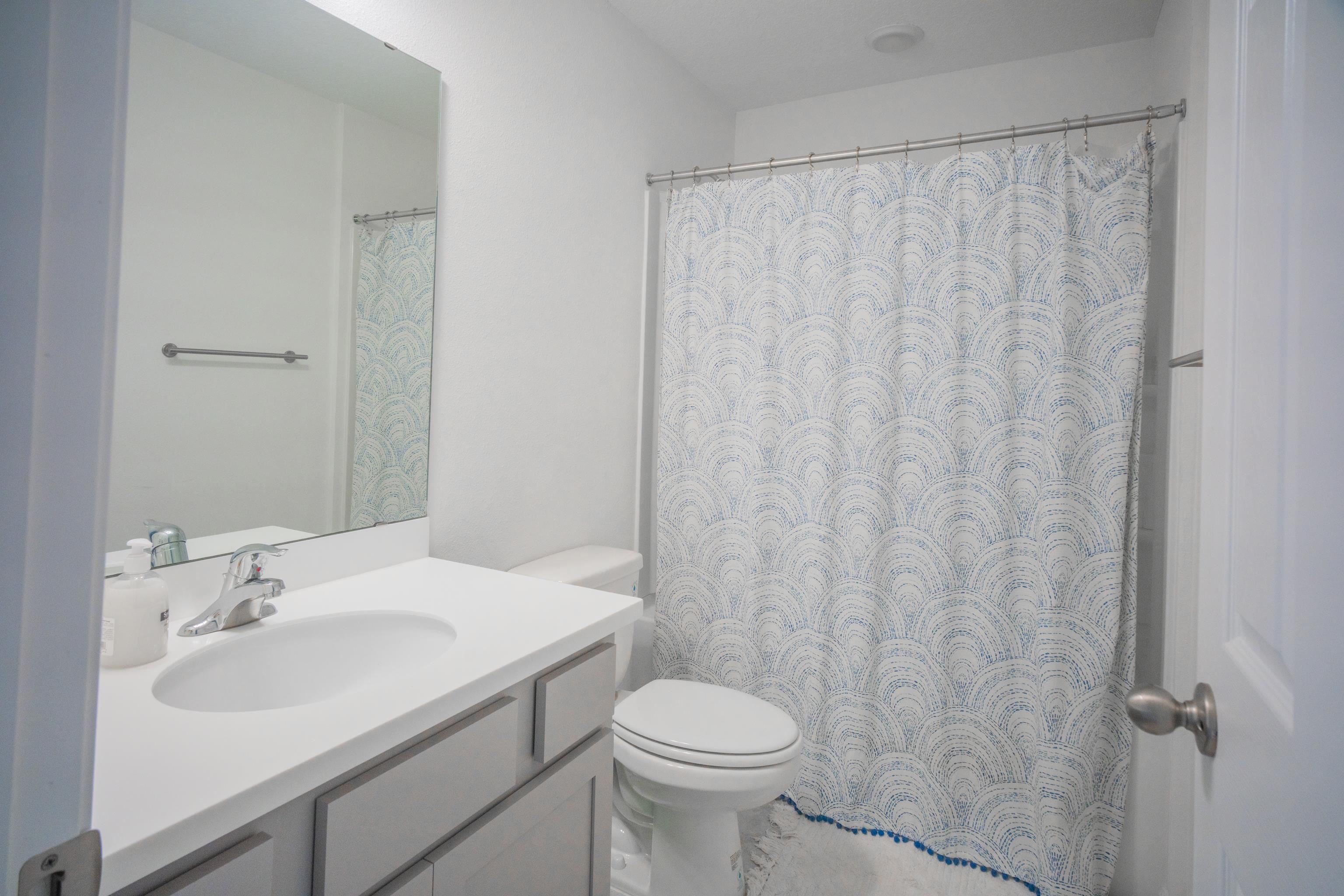 26 Ridge Lake Road St. Augustine, FL 32086 - Photo 9 of 27 a bathroom with a sink toilet and a mirror