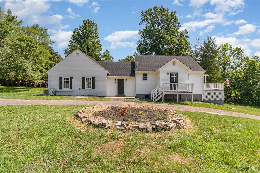 24 Hummingbird Lane Cumberland, VA 23040 - Photo 1 of 38 a front view of a house with a garden and trees