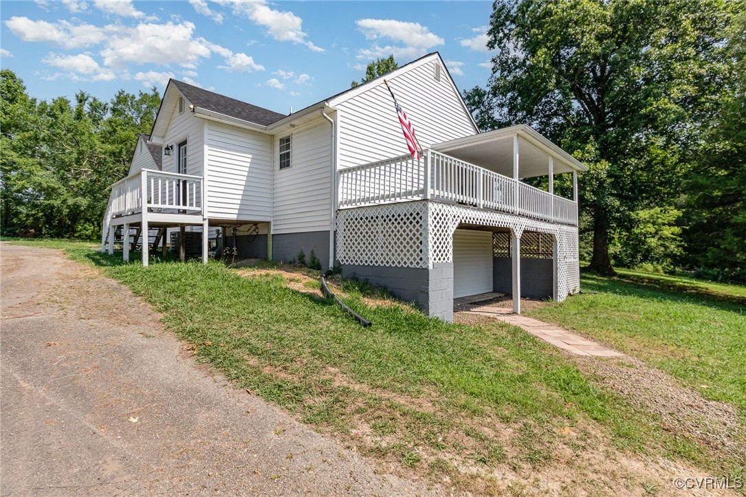 24 Hummingbird Lane Cumberland, VA 23040 - Photo 2 of 38 a front view of a house with a yard and trees